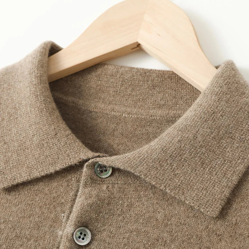 Close-up of a brown sweater with buttons on a wooden hanger