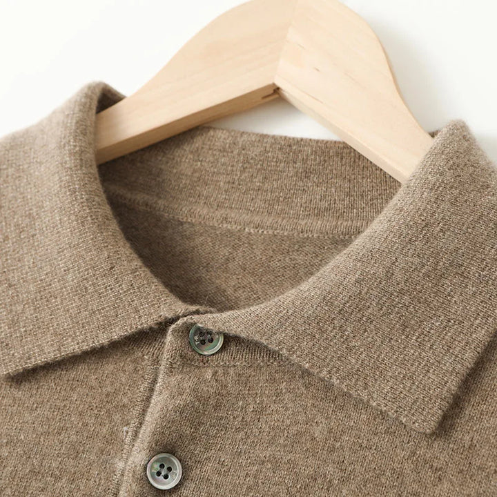 Close-up of a brown sweater with buttons on a wooden hanger