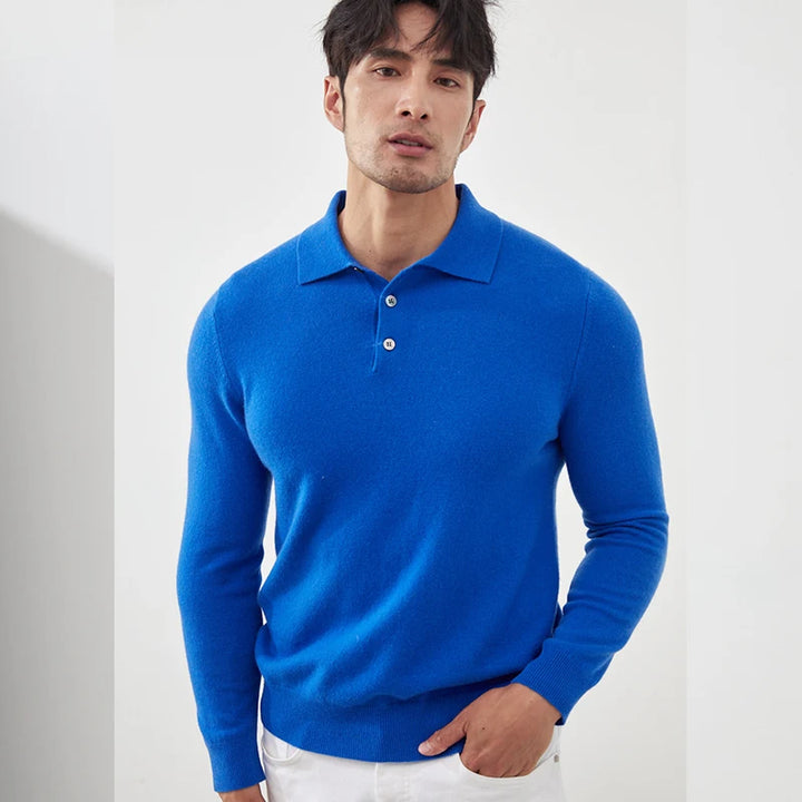 Man wearing a blue long-sleeve polo shirt against a white background