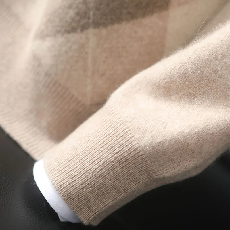 Close-up of a beige sweater sleeve with a checkered pattern on a dark background