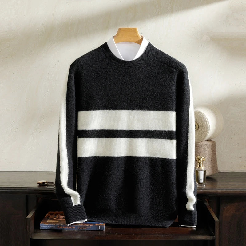 Black sweater with white stripes on a hanger against a neutral background