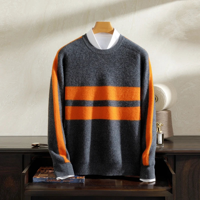Gray sweater with orange stripes on a wooden hanger against a neutral background