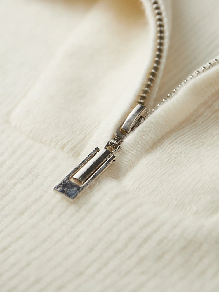 Close-up of a zipper on a cream-colored fabric