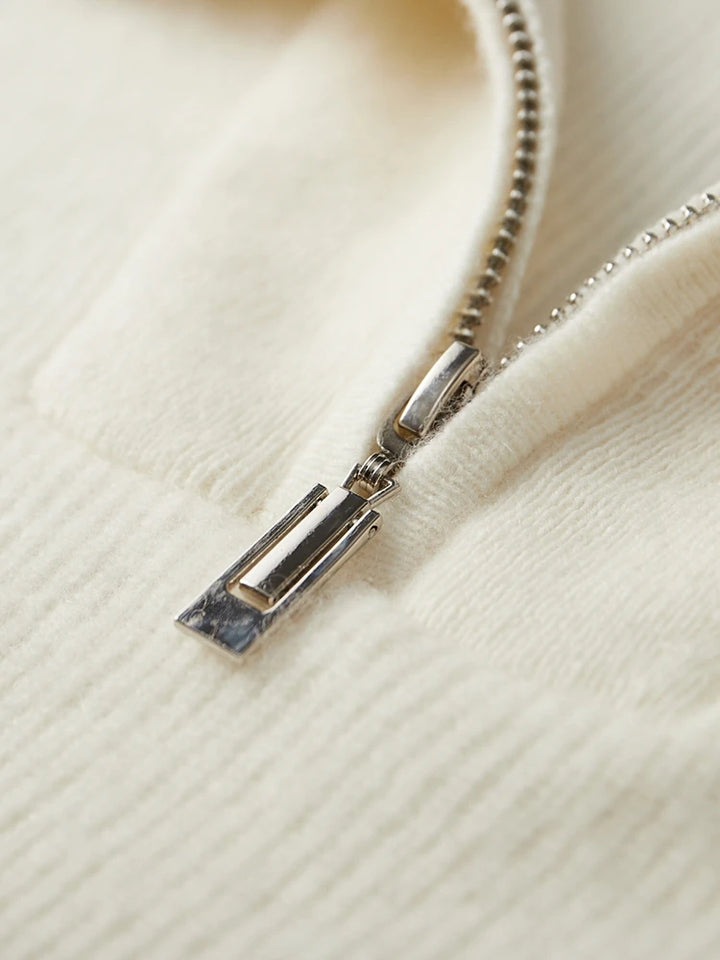 Close-up of a zipper on a cream-colored fabric
