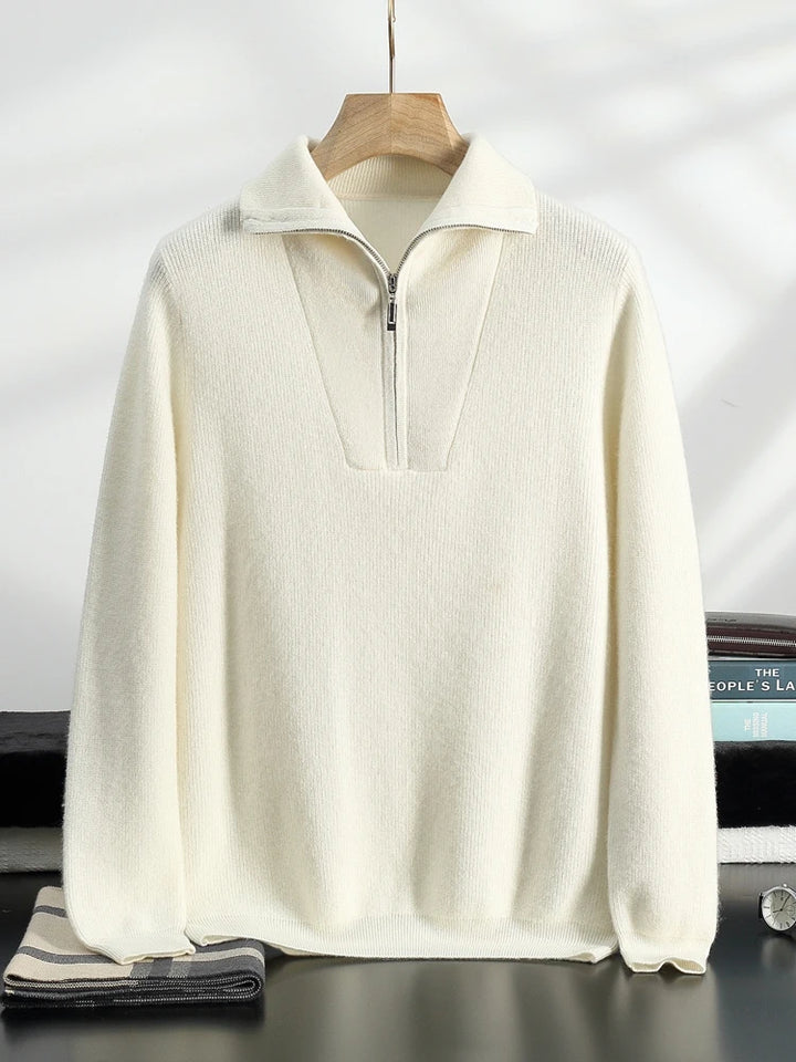 White half-zip sweater on a hanger against a neutral background