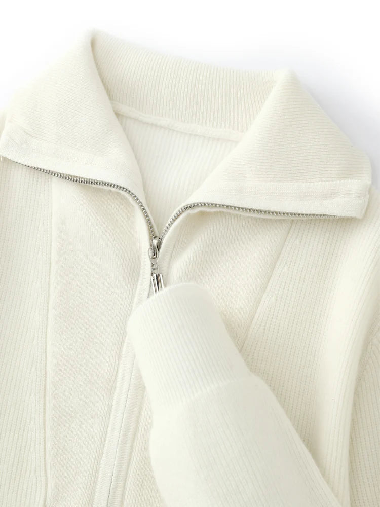 Close-up of a cream-colored zip-up hoodie on a white background