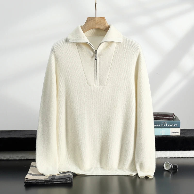 White sweater on a hanger with a neutral background