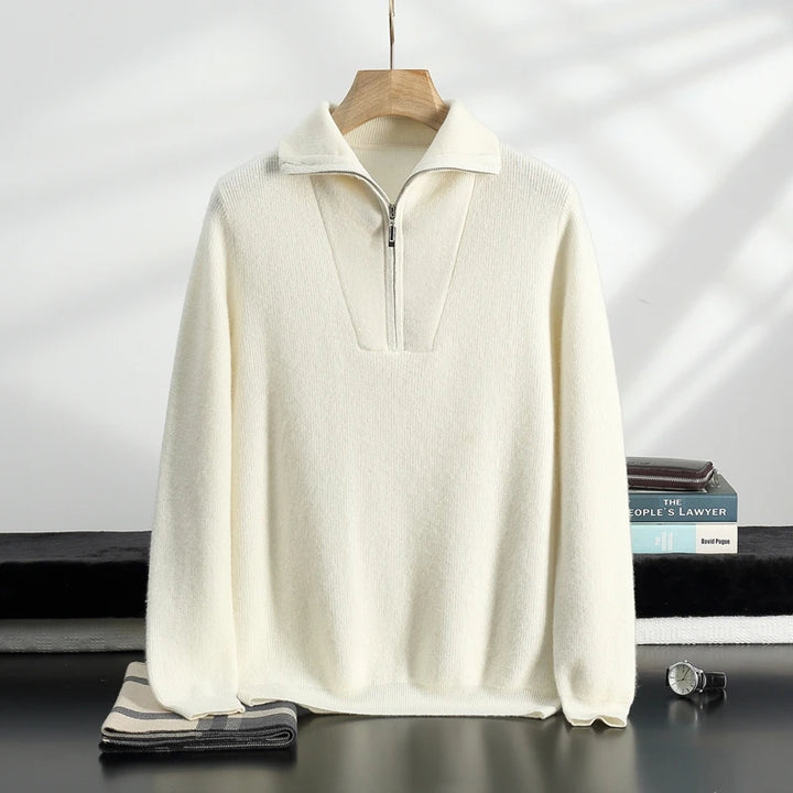 White sweater on a hanger with a neutral background