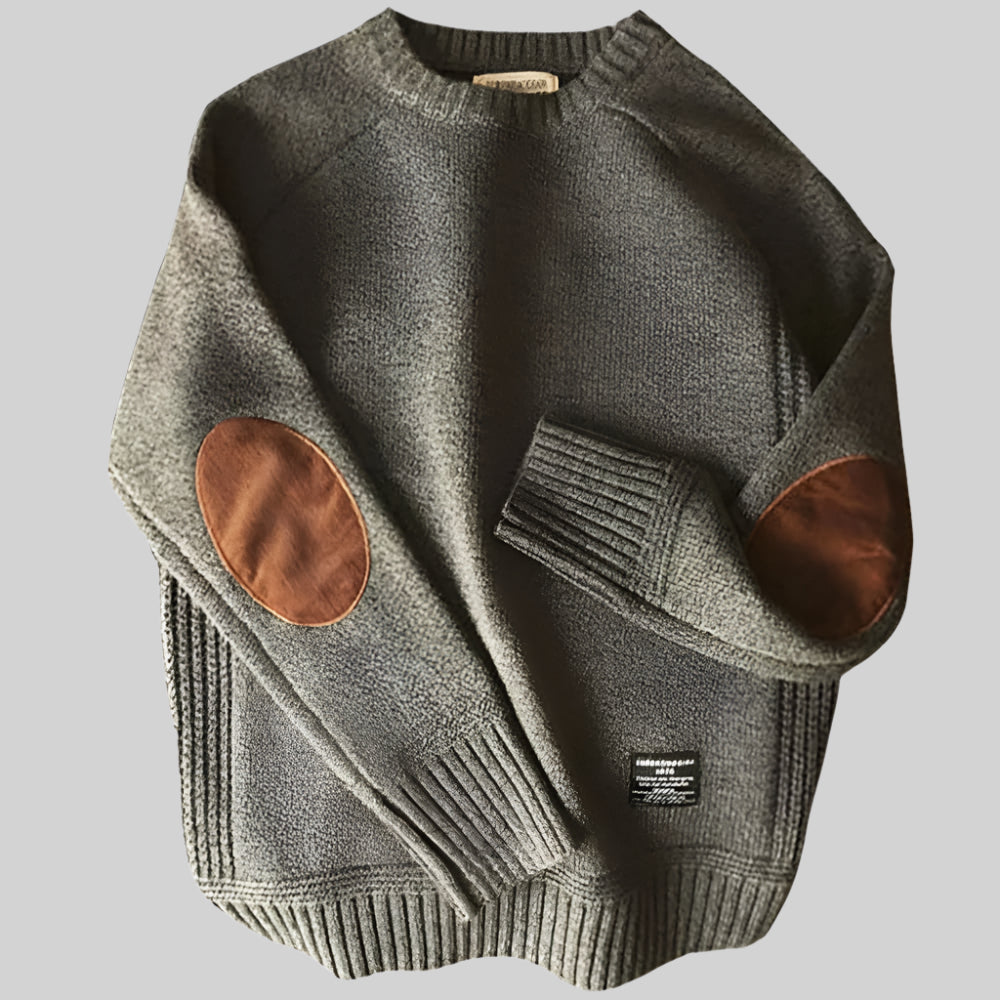 Gray sweater with brown leather patches on a light gray background