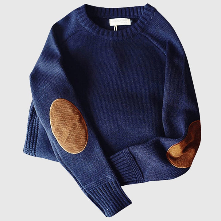 Navy blue sweater with brown elbow patches on a light gray background