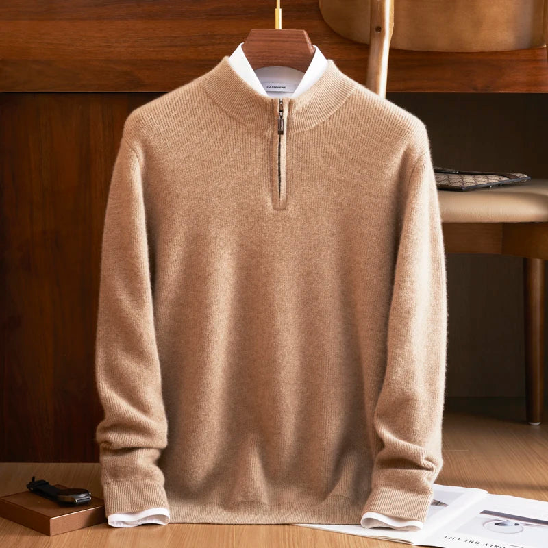 Beige sweater on a hanger against a wooden background