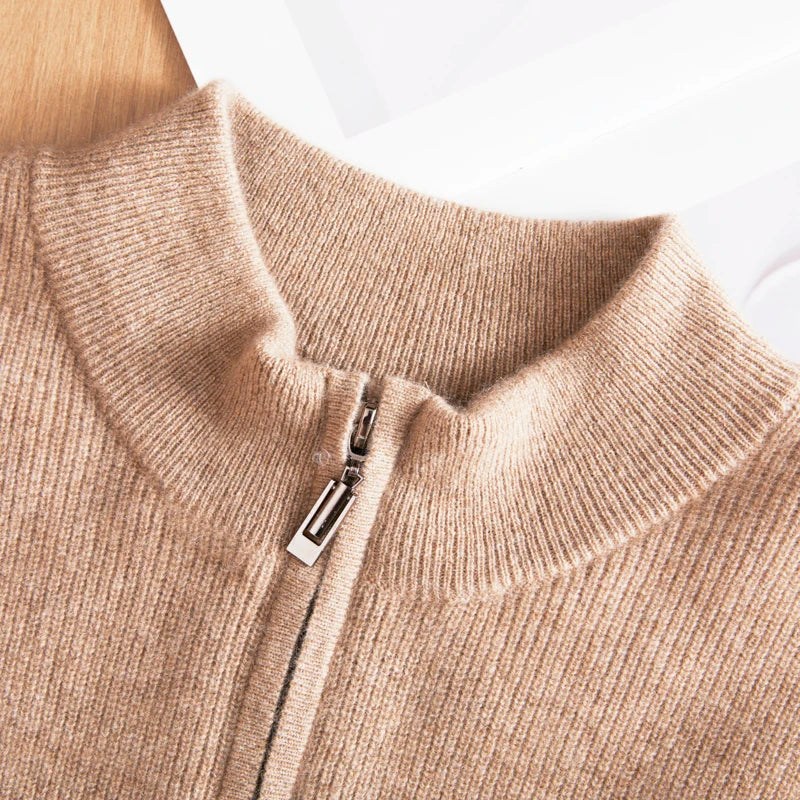 Close-up of a beige sweater with a zipper on a white background