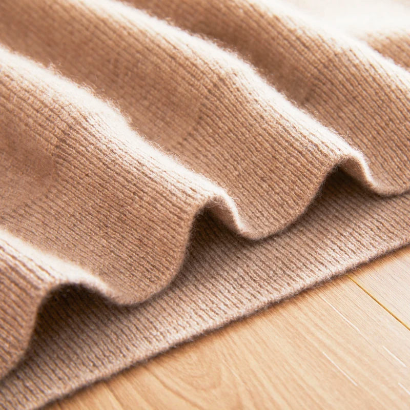 Close-up of a beige textured fabric on a wooden surface
