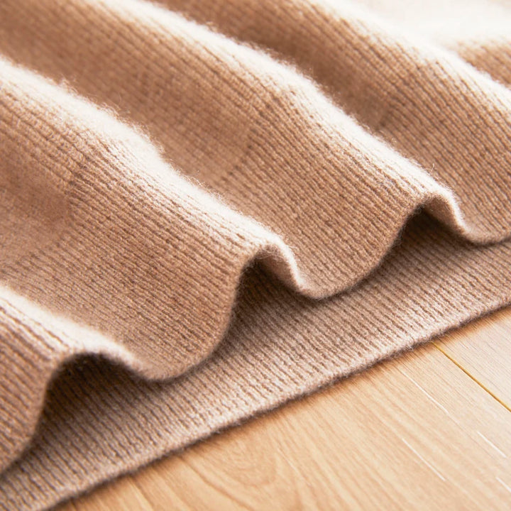 Close-up of a beige textured fabric on a wooden surface