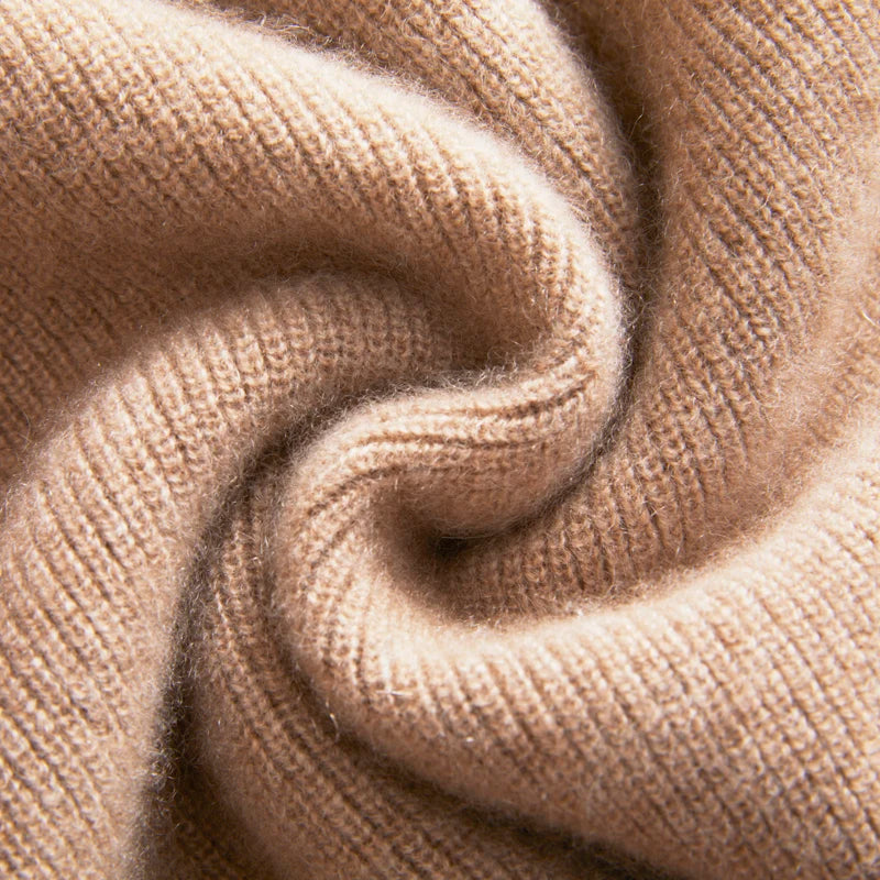 Close-up of beige knitted fabric with a spiral pattern
