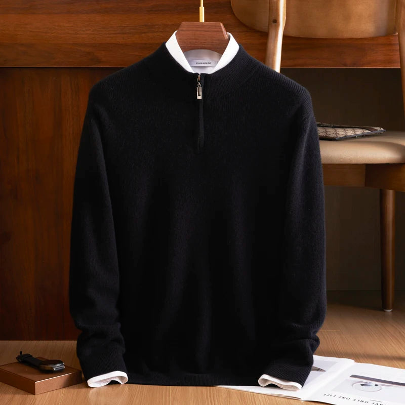 Black sweater with white collar on a wooden hanger against a wooden background