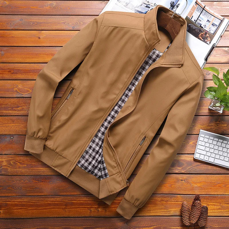Brown jacket on a wooden surface with a magazine and keyboard in the background
