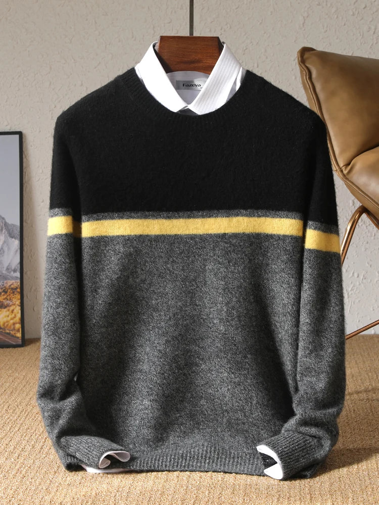 Black and gray sweater with yellow stripes on a hanger against a neutral background