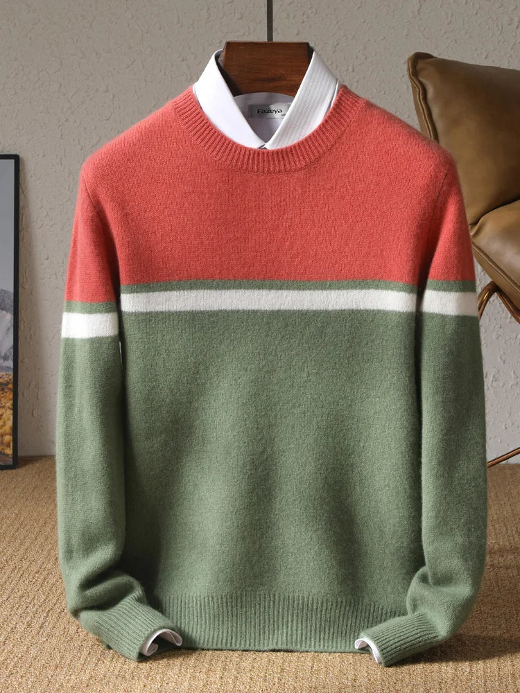 Color-blocked sweater with red, green, and white on a hanger against a neutral background