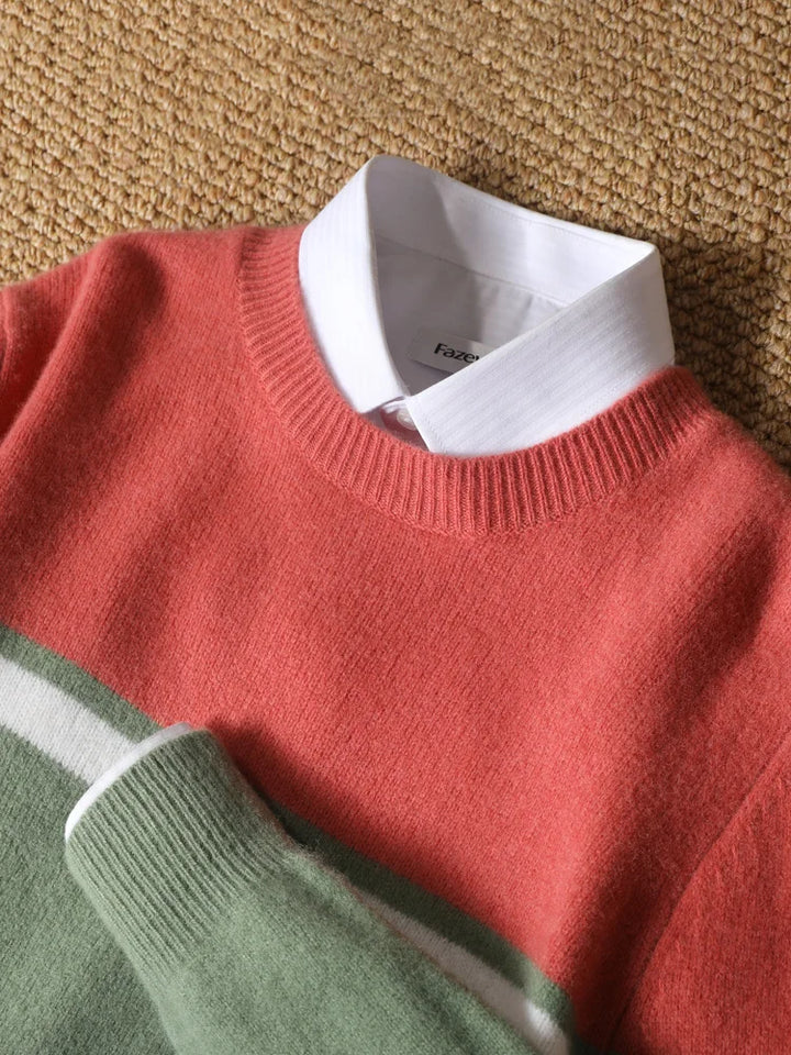 Red sweater with a white shirt collar on a textured surface