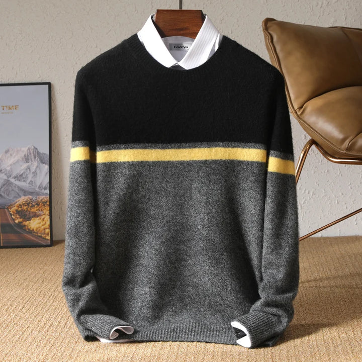 Black and gray sweater with a yellow stripe on a hanger against a neutral background