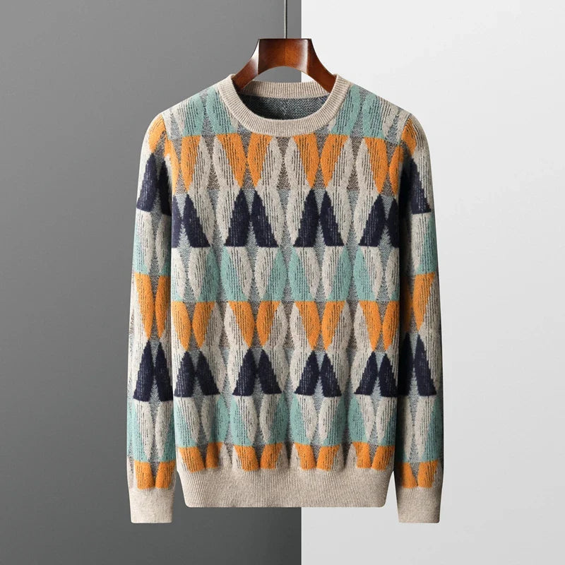 Colorful patterned sweater on a hanger against a gray background