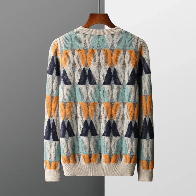 Colorful patterned sweater on a hanger against a gray background