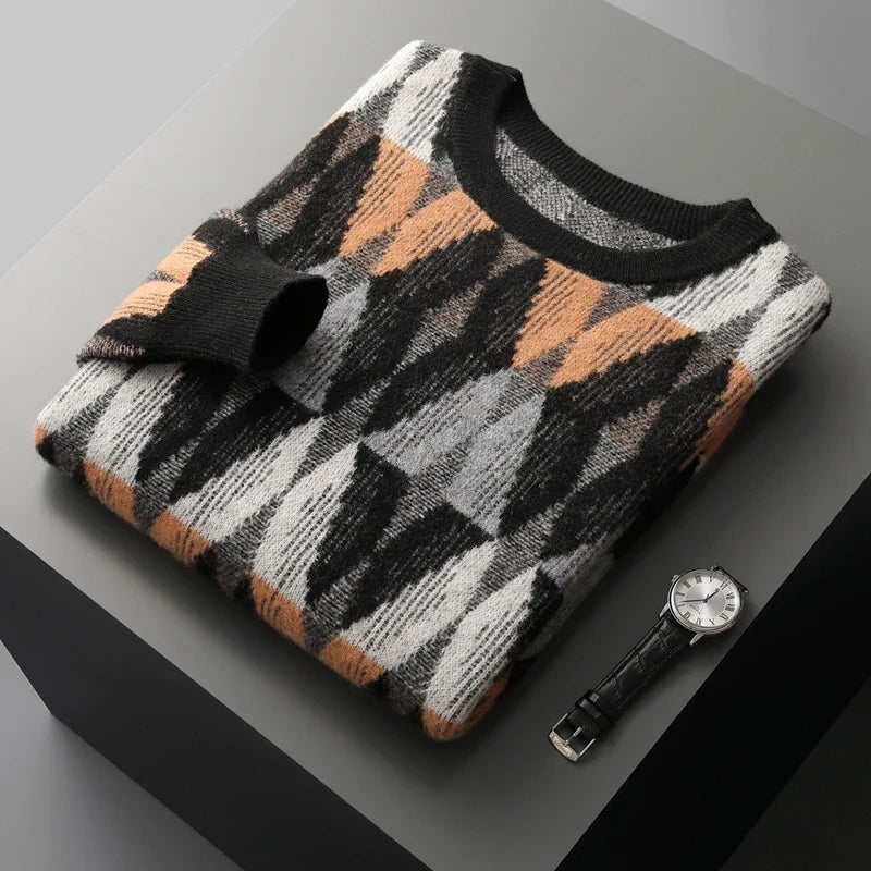 Patterned sweater and watch on a gray surface