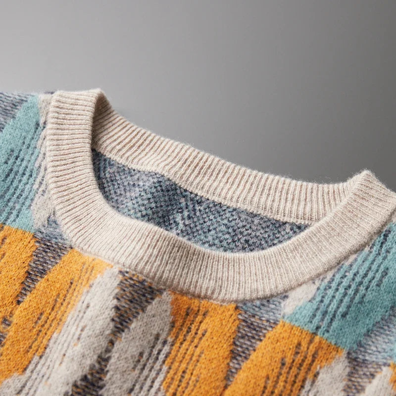 Close-up of a sweater with a patterned design on a gray background