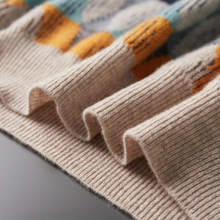 Close-up of beige socks with colorful cuffs on a gray surface