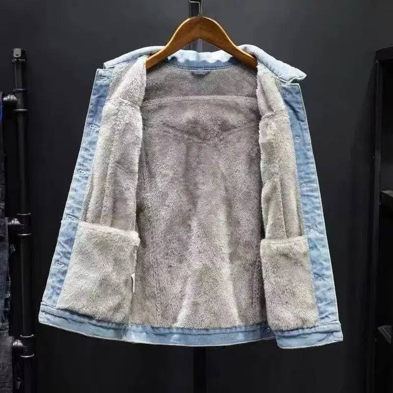 Denim jacket with fleece lining on a hanger against a dark background