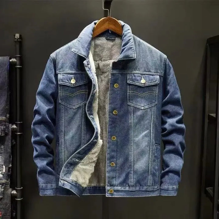 Denim jacket with shearling lining on a hanger against a dark background