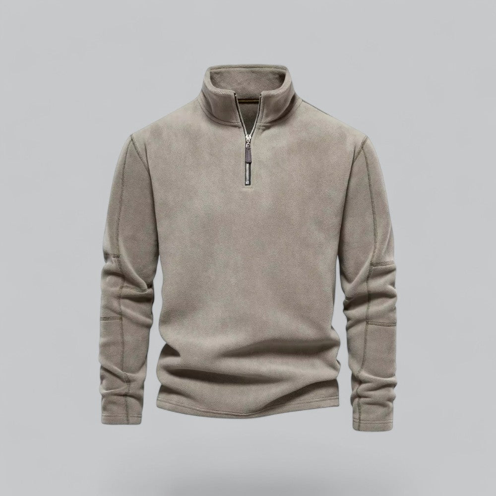 Beige fleece pullover with a zipper on a gray background