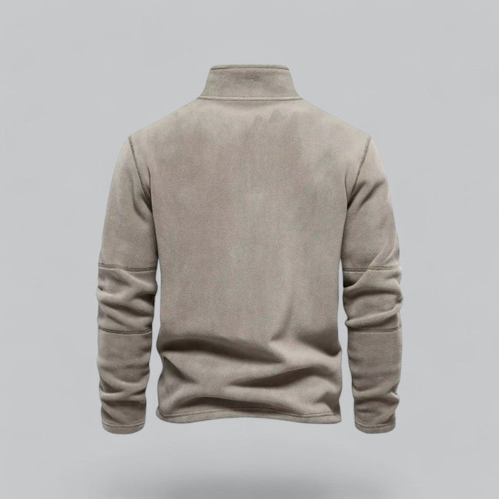 Beige fleece pullover on a gray background