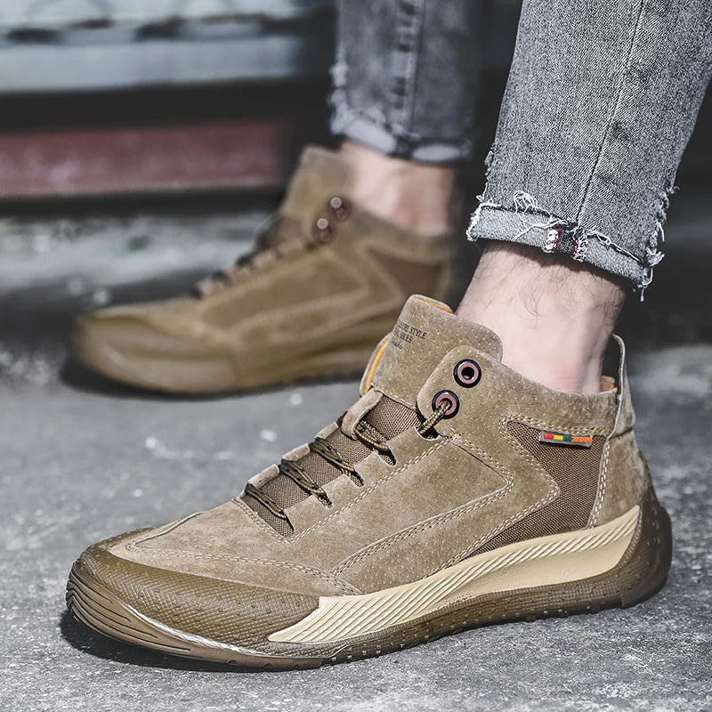 Brown hiking boots worn with jeans on a blurred background