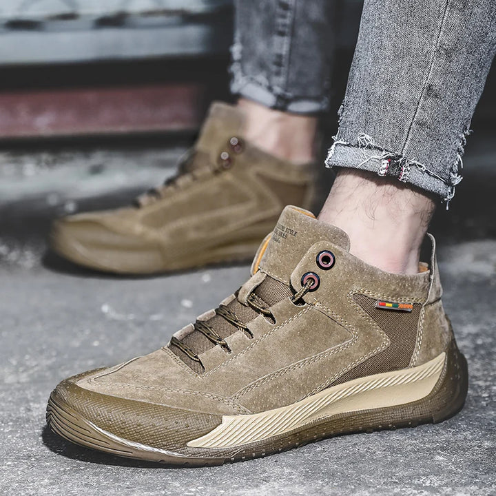Brown hiking boots worn with jeans on a blurred background