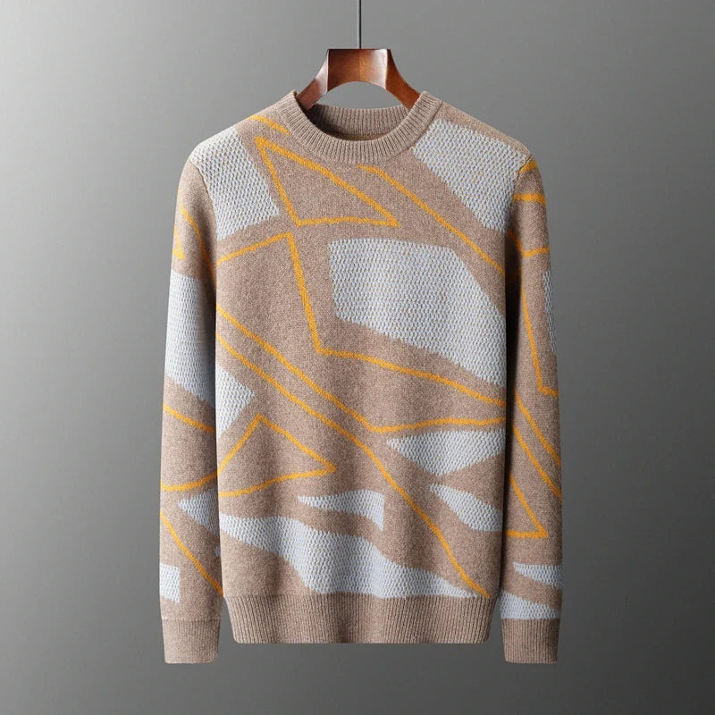 Beige sweater with geometric pattern on a hanger against a gray background