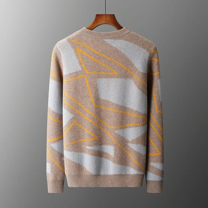 Beige sweater with geometric pattern on a hanger against a gray background