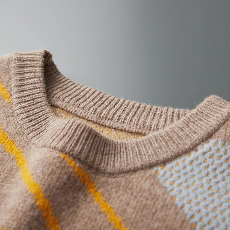 Close-up of a brown sweater with yellow and white pattern on a gray background