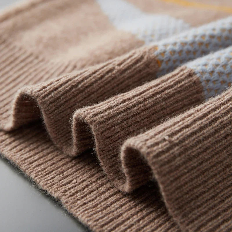Close-up of brown knitted fabric on a light gray surface