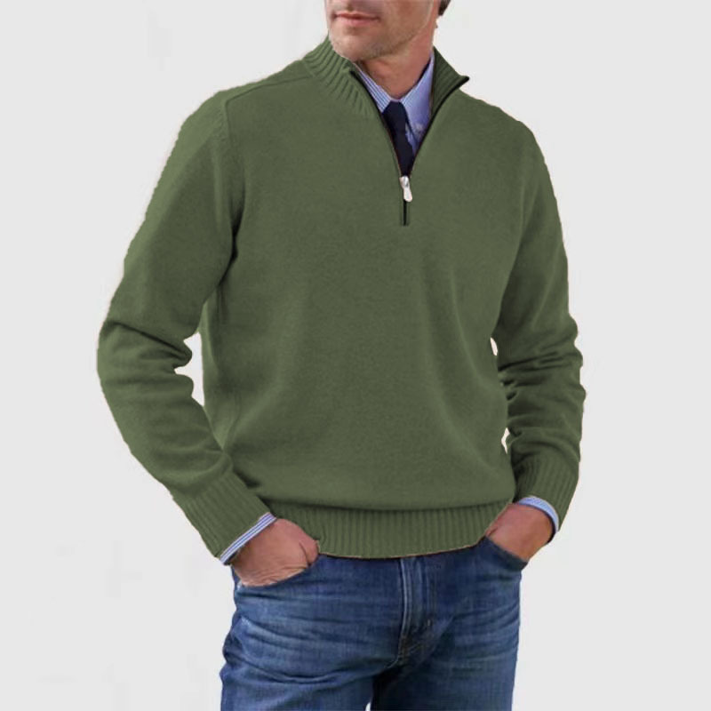 Man wearing a green quarter-zip sweater with a white background