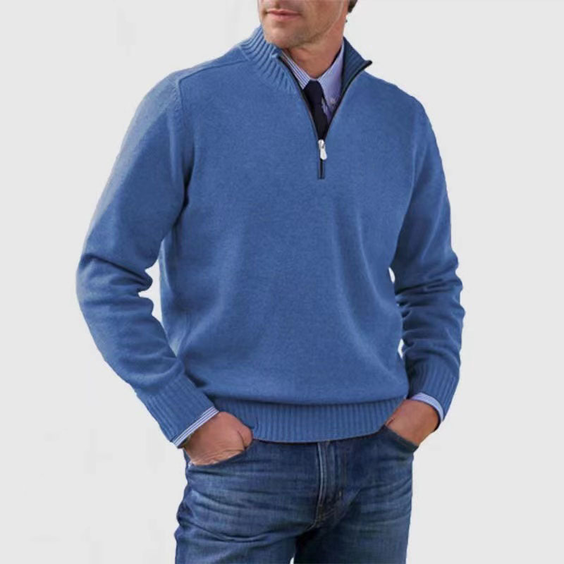 Man wearing a blue sweater with a white background