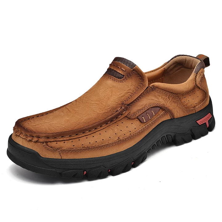 Brown leather shoe with black sole on a white background