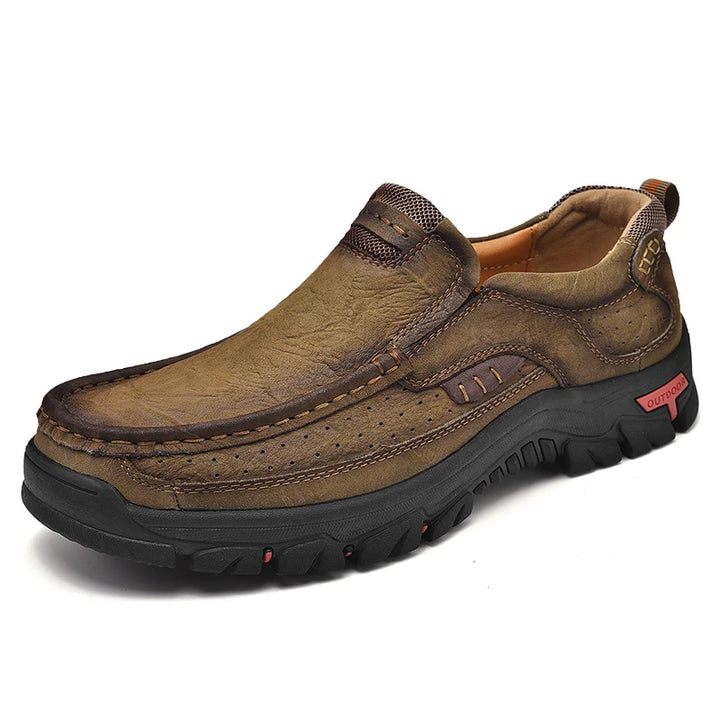 Brown leather shoe with black sole on a white background