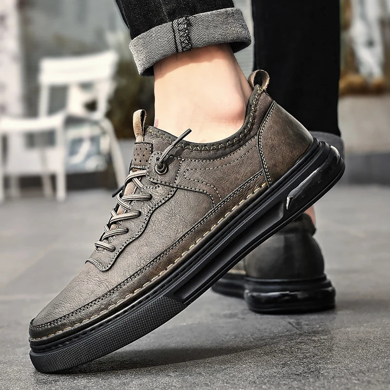 Brown leather shoes with black soles worn by a person on a blurred outdoor background