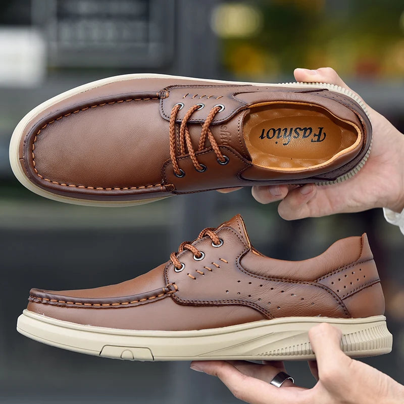 Brown leather shoes held by a person with a blurred background
