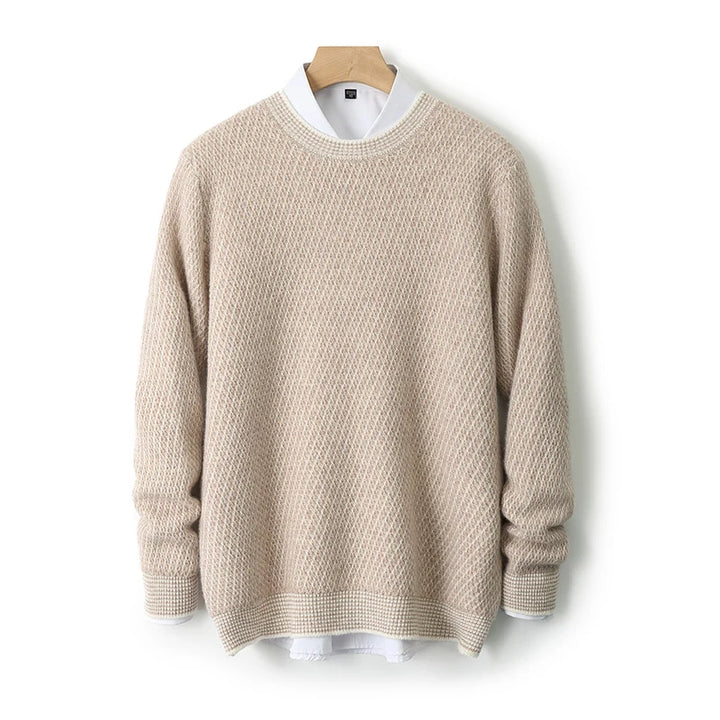 Beige sweater on a wooden hanger against a white background