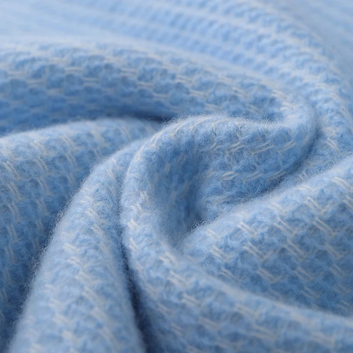 Close-up of a textured blue fabric with a subtle pattern