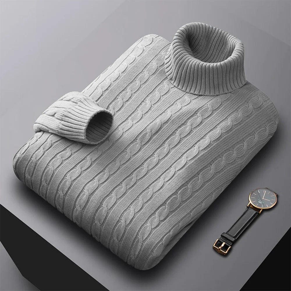 Gray cable knit sweater with a watch on a gray background