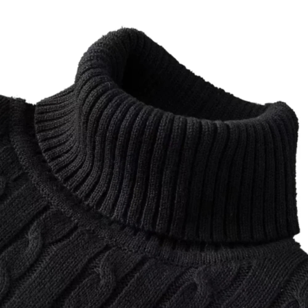 Close-up of a black knitted sweater with a ribbed collar on a white background
